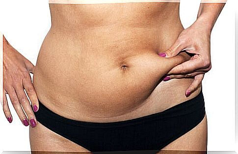 Woman squeezes belly fat