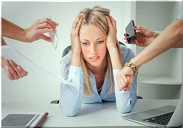 Woman holds her head from the stress