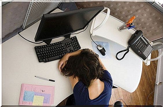 Tired woman lies on her desk