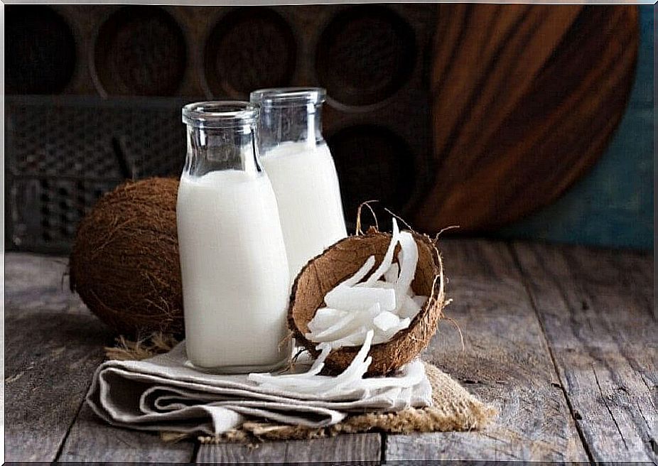 Coconut and bottles of coconut milk