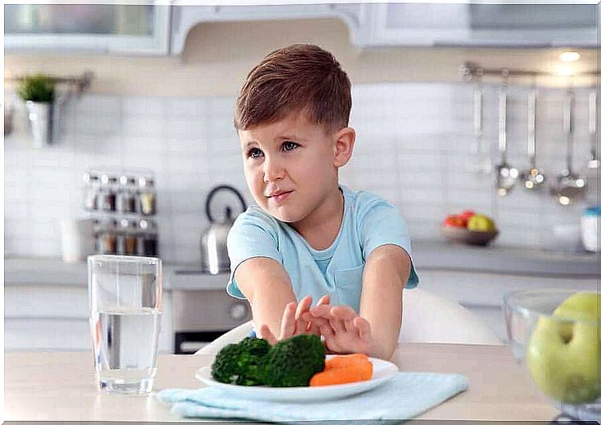 Child pushes his plate away