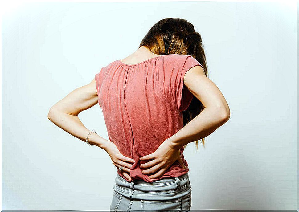 woman holding her lower back