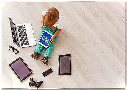 child surrounded by electronic equipment