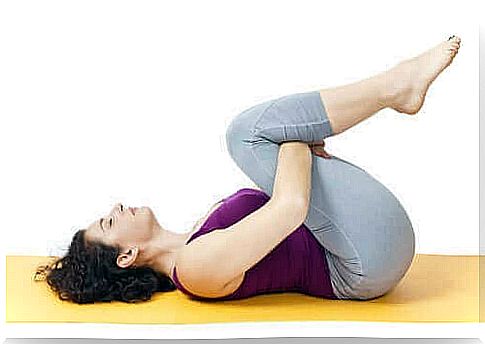 A woman does exercises to strengthen her back