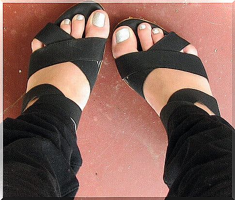 Feet in black sandals