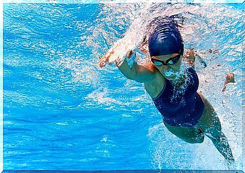 Woman swims underwater in a pool