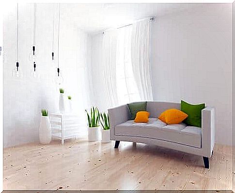 White living room with brightly colored pillows