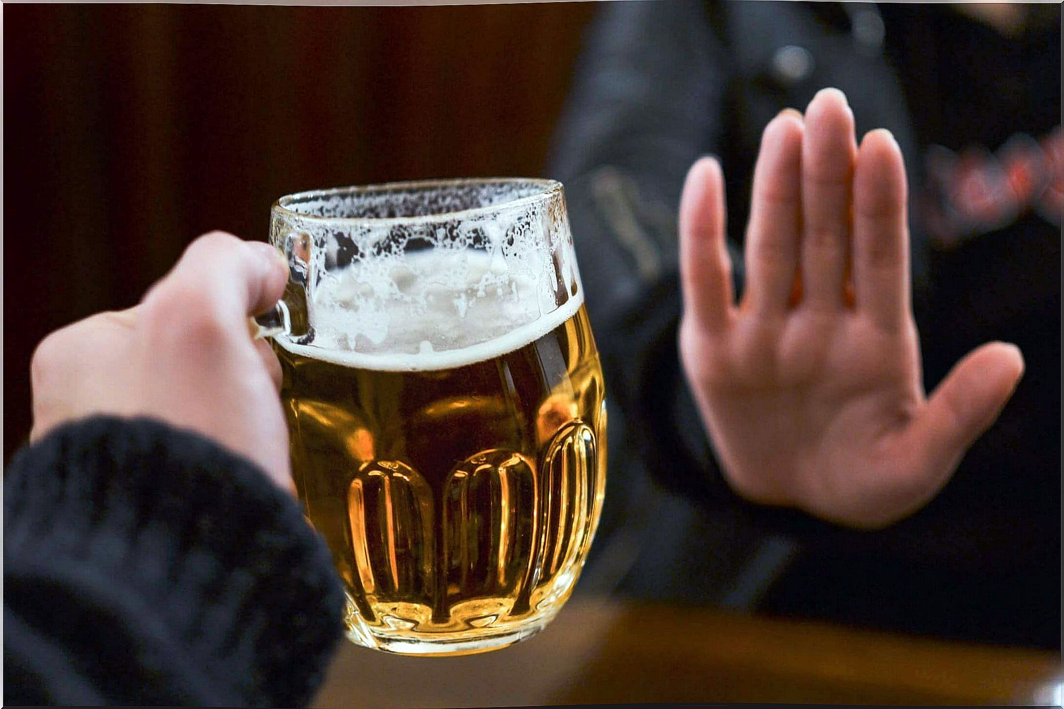 Woman being offered a glass of beer