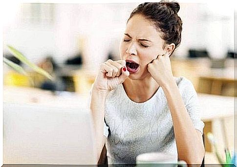 Woman yawns at work