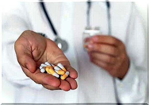 A doctor holds pills in his palm