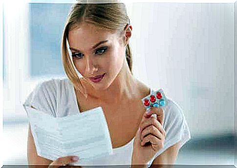 A woman reads the leaflet of a medicine