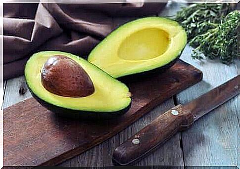 A cut avocado on a board