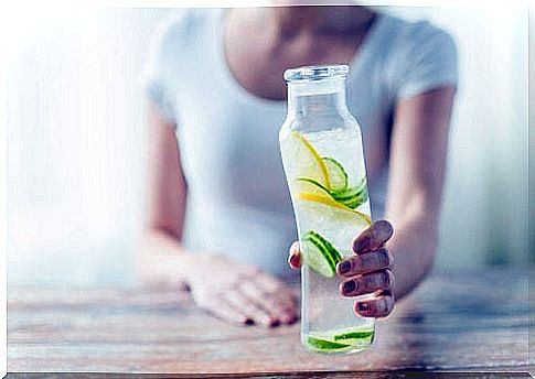 Water with lemon and cucumber in a bottle