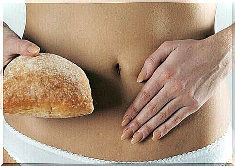 Woman holds bread next to intestines