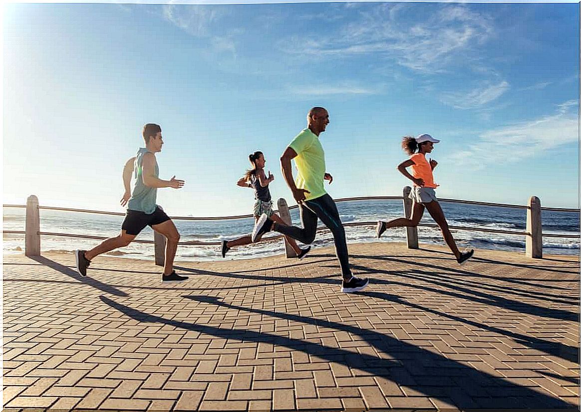 People running along the beach