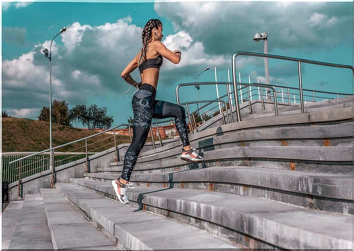 Woman running up a flight of stairs